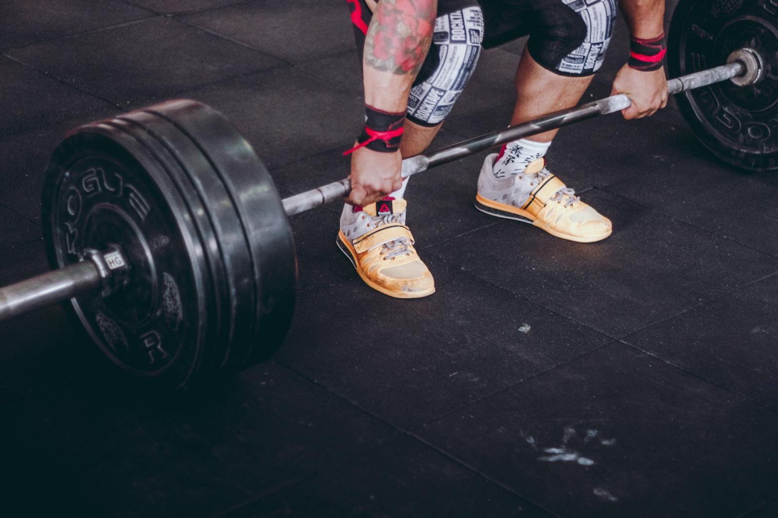 Athlete preparing to deadlift a barbell in the gym