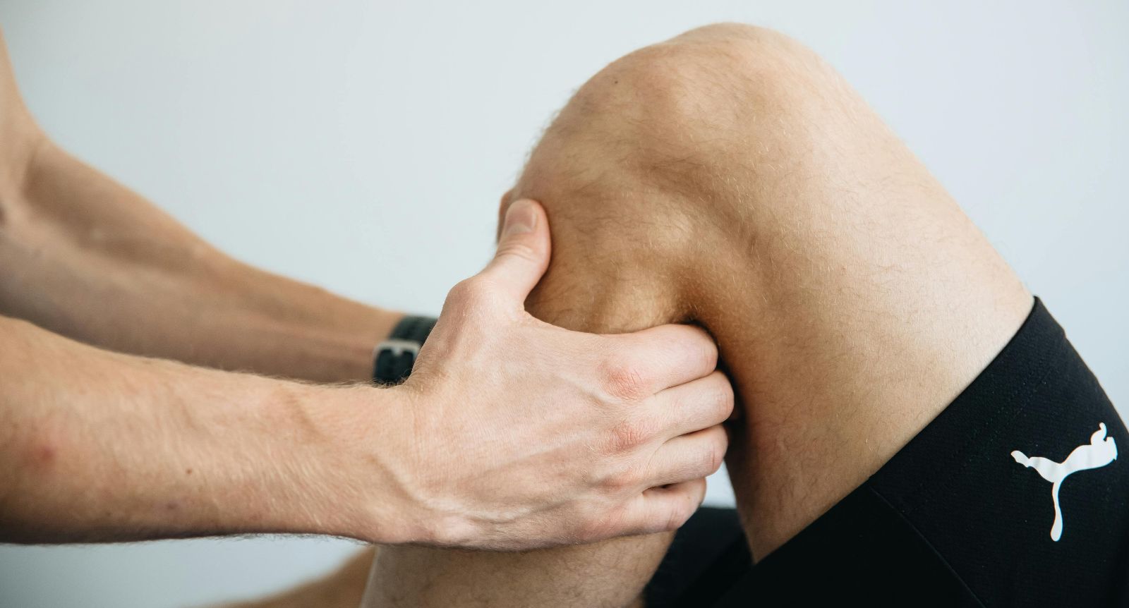 Physiotherapist assessing a patient's knee
